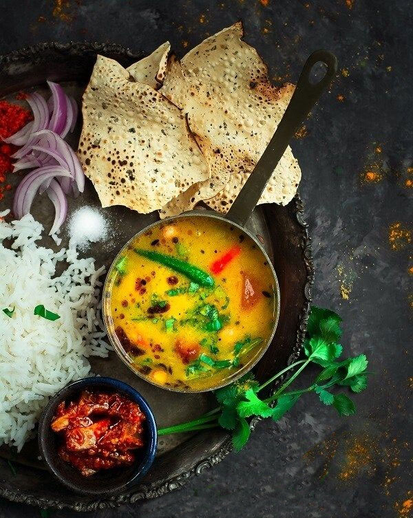 Dal served with rice and papad